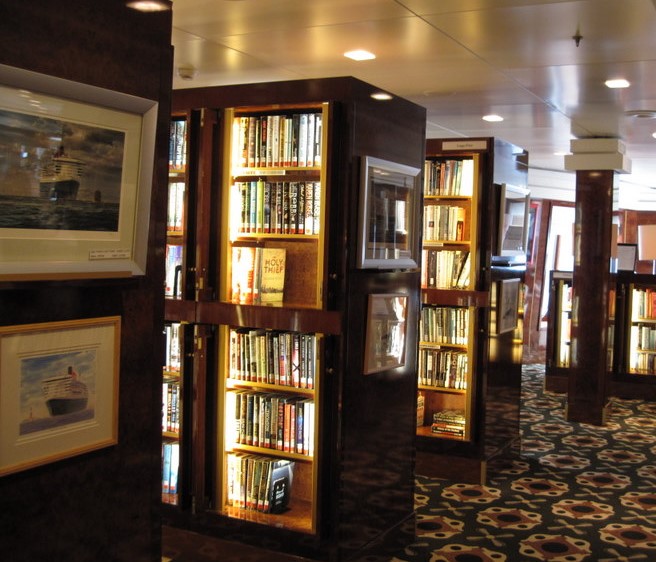 The library has about 10,000 books with lighted wood and glass shelved 