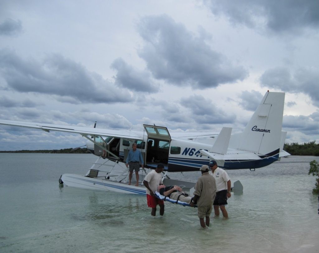 Transporting my husband on a stretcher into the seaplane for evacuation for Coco Cay