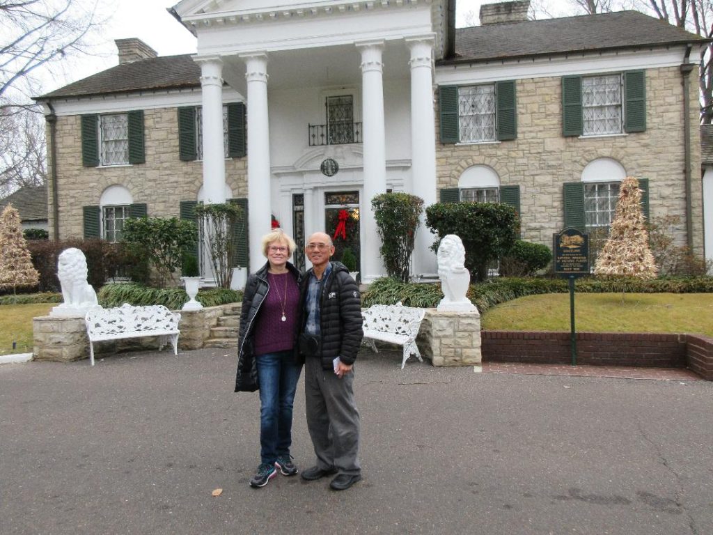 Standing in front of Graceland Mansion in Memphis.